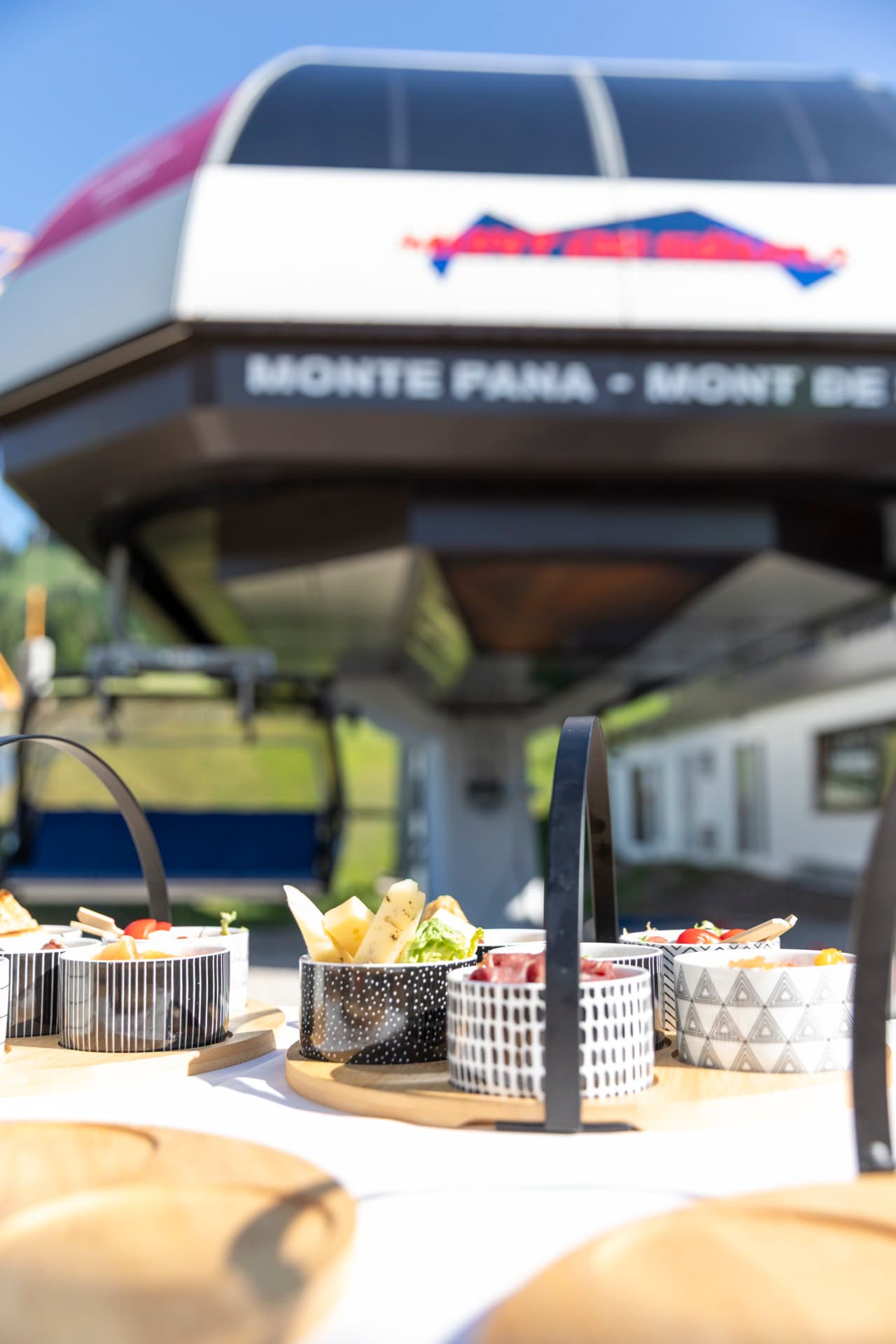 The chairlift cabin lettered “Monte Pana · Mont de Sëura” at the valley station.